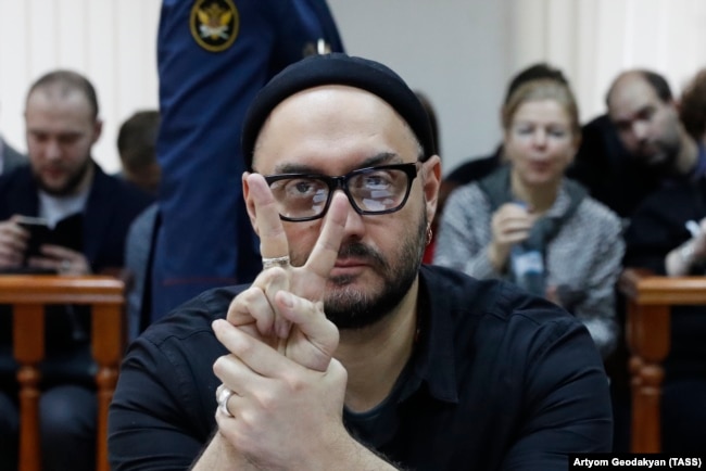 Kirill Serebrennikov flashes a victory sign as he attends a court hearing in Moscow on December 4.