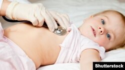 Педиатр со стетоскопом слушает биение сердца ребенка. Иллюстративное фото.