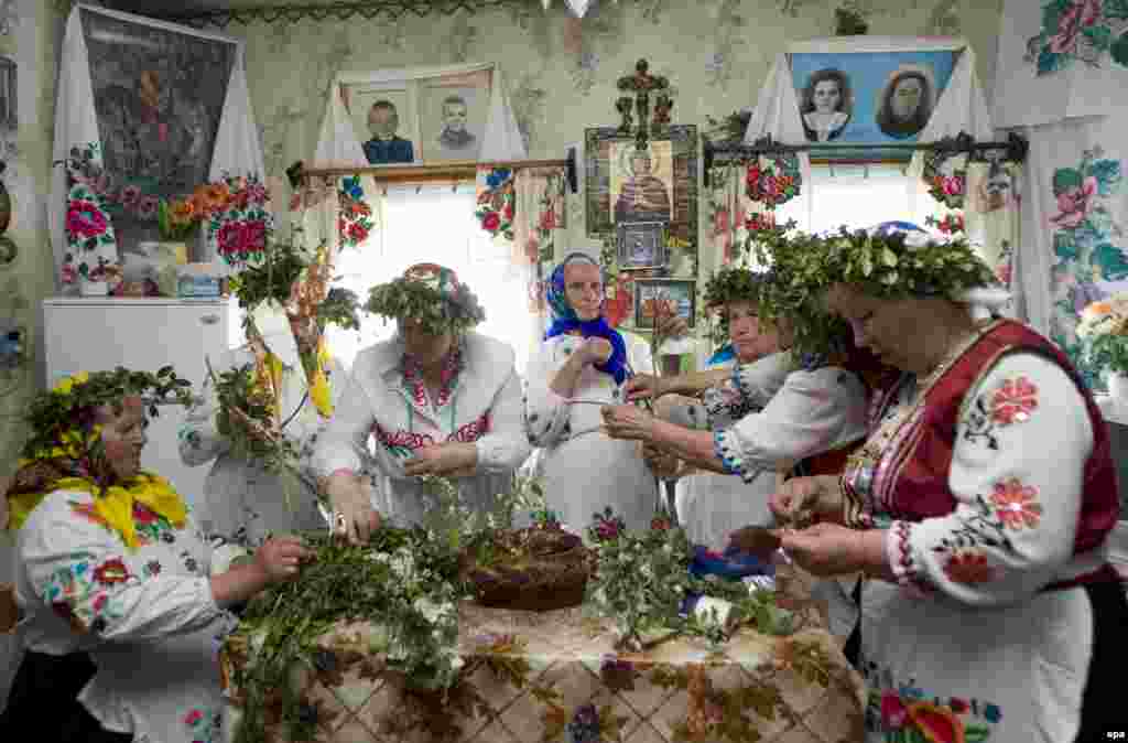 Yurya celebration in Belarus - Belarusian women wearing traditional dresses prepare the round loaf for the pagan Yurya celebration in the village of Pagost, 230 km from Minsk, Belarus, 06 May 2008. The tradition is devoted to bread and good future harvests. 
