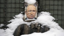 A bullet-riddled effigy of Russian President Vladimir Putin is coated by fresh snow at a frontline position in Ukraine's eastern Luhansk region in February 2022.