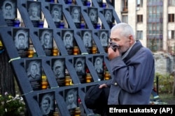 A man pays his respects at a memorial in Kyiv dedicated to the "Heavenly Hundred," a term for protesters who were killed in crackdowns by security forces during the protests.