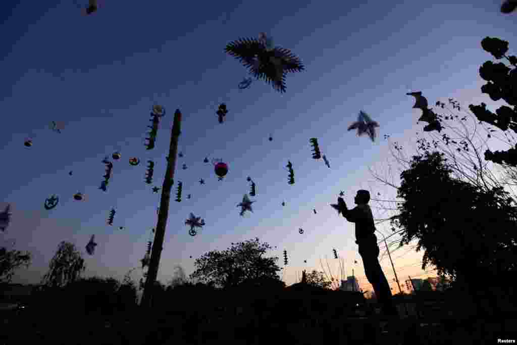 A man decorates a Christian neighborhood ahead of Christmas celebrations in Islamabad, Pakistan. (Reuters/Faisal Mahmood)