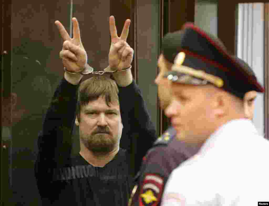 Leonid Razvozzhayev, co-defendant of opposition leader Sergei Udaltsov, gestures from the defendants&#39; cage during a court hearing in Moscow on July 24. Both men were found guilty. (&nbsp;Reuters/Maksim Shemetov)