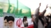 Iranian flag with portraits of Islamic Republic's founder, Ayatollah Ruhollah Khomeini (left), and his successor, Ali Khamenei, at a Tehran protest in mid-December.