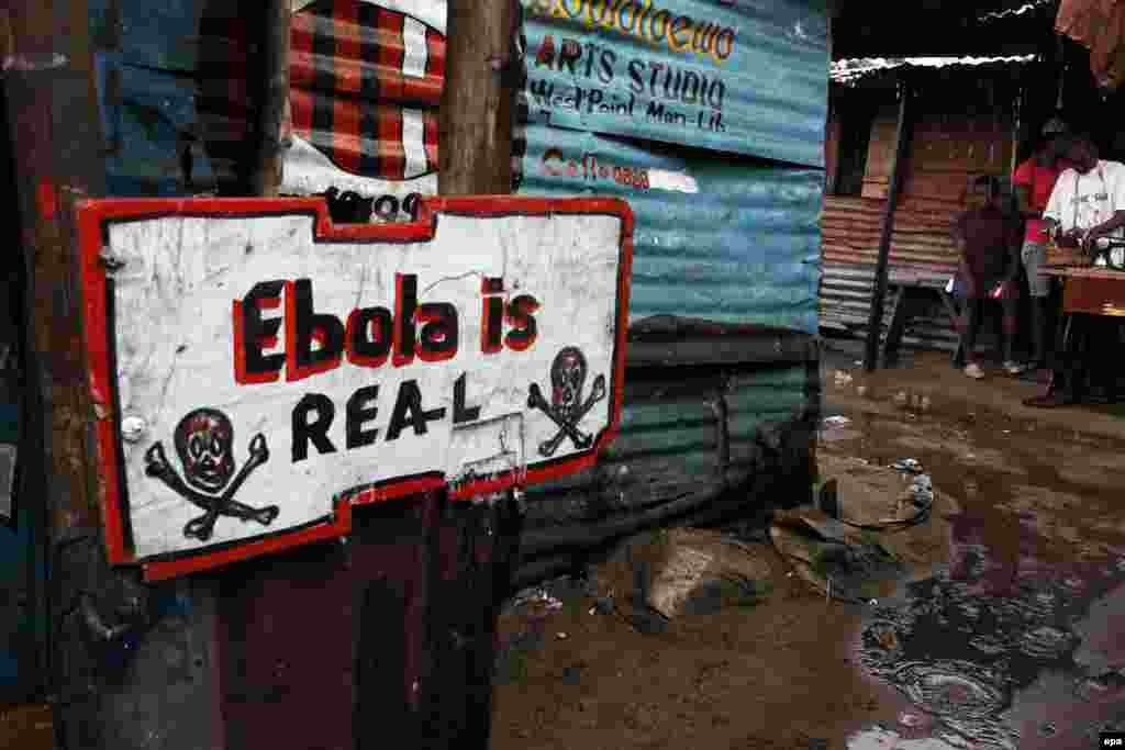 A sign warns of the danger of Ebola in West Point, a slum area of the Liberian capital, Monrovia, on September 25. The area was among the worst affected by the Ebola outbreak in West Africa. (Ahmad Jallanzo, epa)