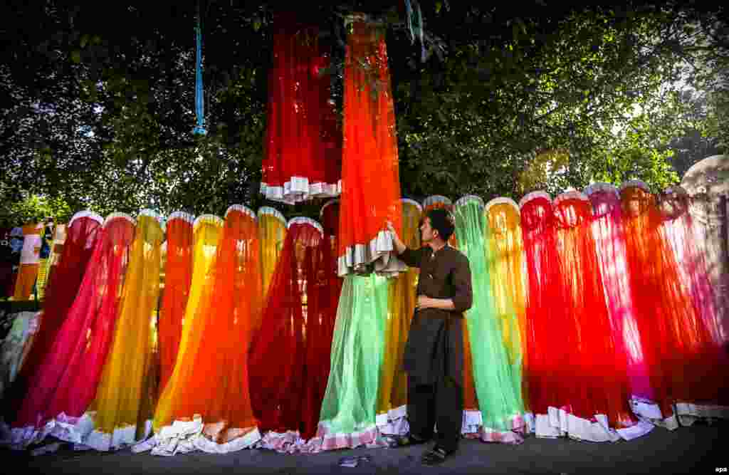 A man waits for customers as he sells mosquito netting in Peshawar, Pakistan. (epa/Bilawal Arbab)