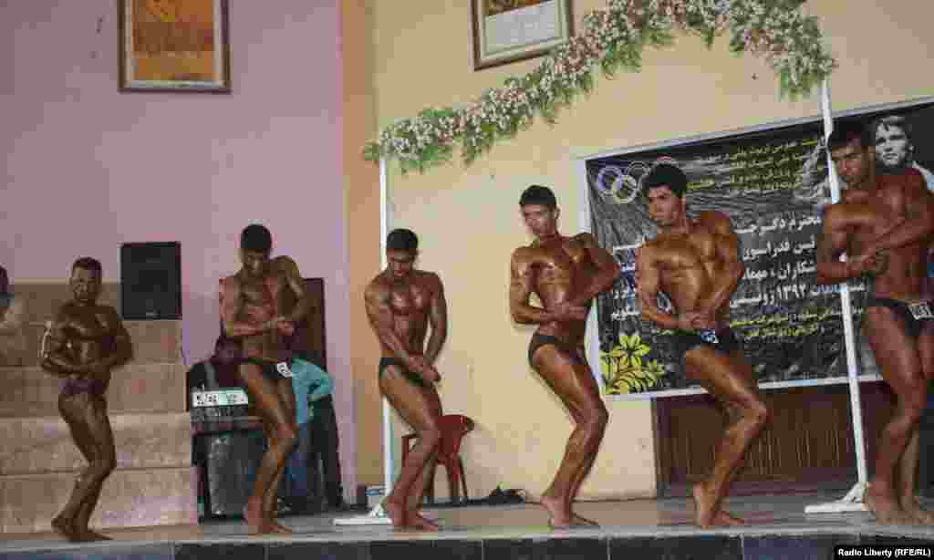 Afghanistan -- Men strike a pose during a National bodybuilding competition in Kabul on 15march 2013