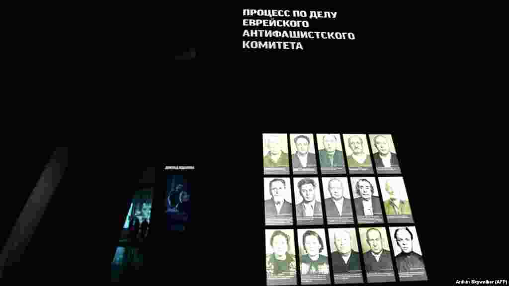 Visitors walk in Jewish Museum in Moscow. The sign above the photos (right) reads: "The Jewish Anti-Fascist Committee Trial."