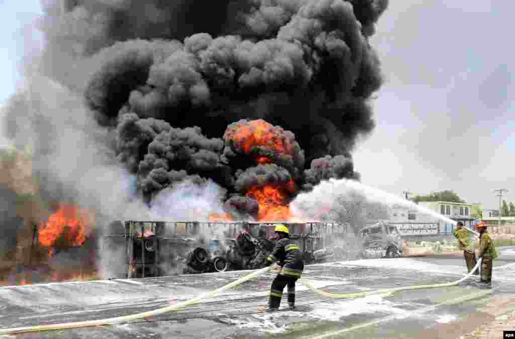 Afghan firefighters try to extinguish burning NATO oil tankers following an attack by militants in the Sarharood district of Nangarhar on July 23. (epa/(Ghulamullah Habibi) 