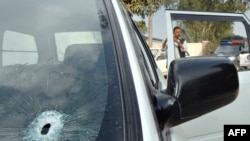 The bullet-riddled car of the kidnapped Iranian diplomat in Peshawar