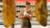 A customer tries to decide which meat to choose at a grocery store in Moscow on August 18. 