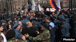 Armenia - Riot police confront anti-LGBT protesters outside the parliament building in Yerevan, April 8, 2019.