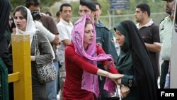 In an undated photo, Iranian police warn women about their clothing and hair during a crackdown to enforce Islamic dress code.