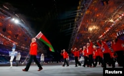 Belarusian flag-bearer Aleksei Grishin leads his country's contingent during the opening ceremony of the 2014 Sochi Winter Olympic Games in February.