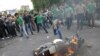 Supporters of Iranian presidential candidate Mir Hossein Musavi burn a police motorcycle during a protest on Valiasr Street in Tehran on June 13, 2009.