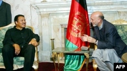 Afghan President Hamid Karzai (right) meets Ali in Kabul in 2002.