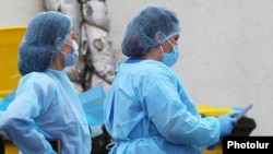 Armenia -- Medical workers are seen outside the Nork hospital in Yerevan where coronavirus patients are treated, March 20, 2020. 