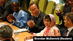 Pakistan - Malala Yousafzai (2nd R), is introduced before her first speech since the Taliban in Pakistan tried to kill her for advocating education for girls, at the United Nations Headquarters in New York, July 12, 2013.