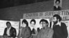 Iran - Three unidentified U.S. hostages speak to the press while their Iranian captors (L and R) watch closely, at the besieged U.S. embassy in Tehran, Nov1979