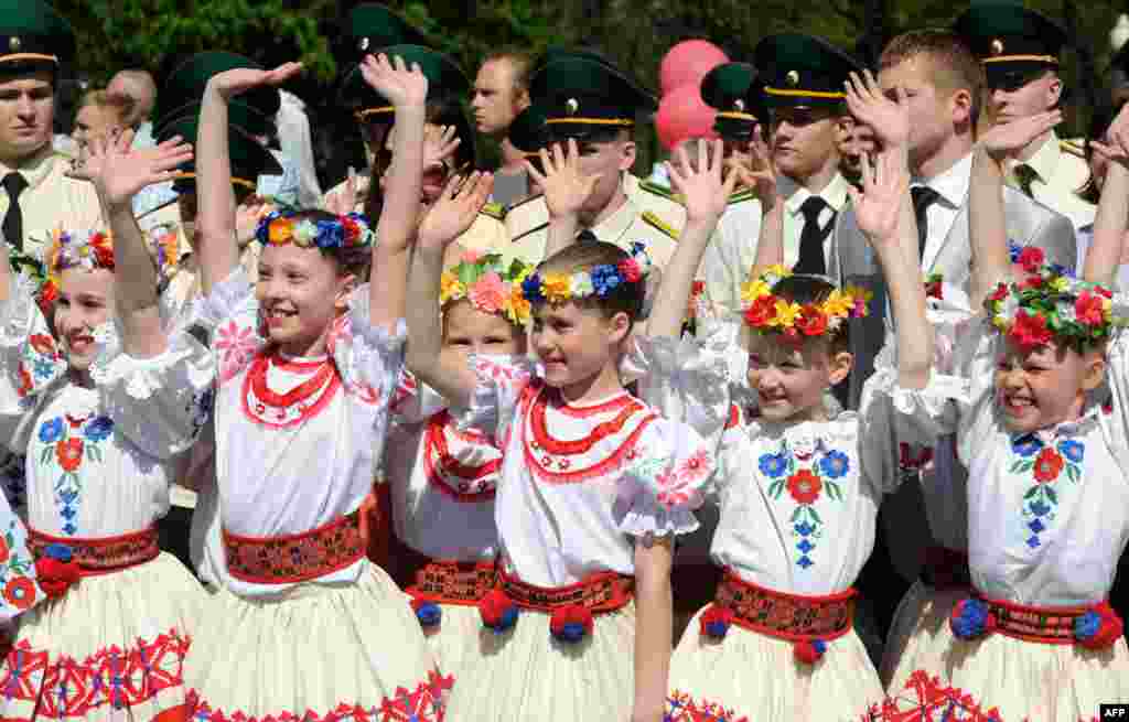 Belarusian girls, wearing traditional costumes, take part in Victory Day celebrations in Minsk. (AFP/Viktor Drachev) 