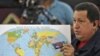 Venezuela -- President Hugo Chavez holds a chocolate bar and a map during his weekly "Alo Presidente" broadcast in the town of Caucagua, 31Oct2010