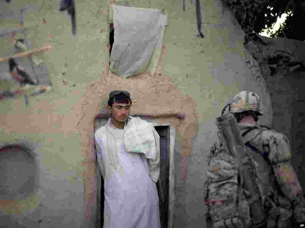 Sharif Ullah looks on as soldiers with the Canadian Army's 1st Battalion Royal 22nd Regiment search his compound during their final operation in the Panjwaii district of Kandahar Province, Afghanistan. Photo by David Goldman for AP