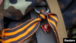 A pro-Russian rebel wears a St. George ribbon.