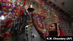 A Pakistani Hindu woman rings a bell to celebrate Diwali at a local temple in Lahore. Hindus make up less than 4 percent of Pakistan's overwhelmingly Muslim population of around 216 million people.