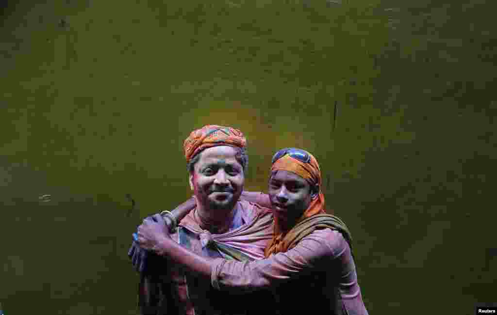 Two Hindu devotees pose for a picture during Holi celebrations in a lane near the Bankey Bihari temple in Vrindavan in the northern Indian state of Uttar Pradesh. (Reuters/Vivek Prakash)