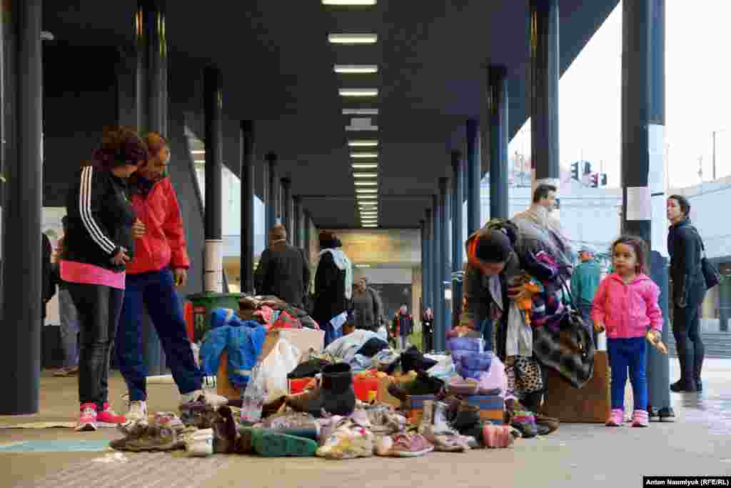 Shoes and clothes have been placed in piles on the floor so that anyone can take what they need.