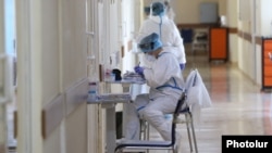 Armenia -- A medical worker takes notes at the Surp Grigor Lusarovich Medical Center in Yerevan, the country's largest hospital treating coronavirus patients, June 5, 2020.