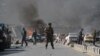 An Afghan security force member stands at the site of a massive car bomb attack in Kabul on May 31.
