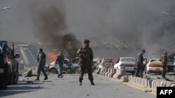 An Afghan security force member stands at the site of a massive truck-bomb attack in Kabul on May 31 that killed more than 150 people.