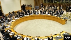 UN Security Council members raise their hands in the June 9 vote to impose a fourth round of sanctions on Iran over its nuclear activities.