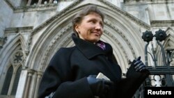 Aleksandr Litvinenko's widow, Marina, who has battled for a full public inquest into her husband's death, leaves the High Court in London in March.