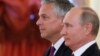 Russian President Vladimir Putin (right) and the new U.S. ambassador to Russia, Jon Huntsman, attend a ceremony during which Putin receives diplomatic credentials from foreign ambassadors at the Kremlin on October 3.