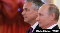 Russian President Vladimir Putin (right) and the new U.S. ambassador to Russia, Jon Huntsman, attend a ceremony during which Putin receives diplomatic credentials from foreign ambassadors at the Kremlin on October 3.