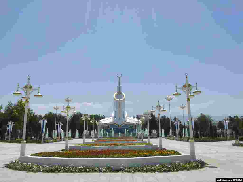 Turkmenistan. View to the new monument "Ak saherim". Flowers. May 26, 2014