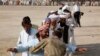 A soldier checks a man fleeing a military offensive in South Waziristan. (file photo)