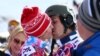 Russia -- Alena Zavarzina and Vic Wild of Russia kiss after the Snowboard Parallel Giant Slalom races at Rosa Khutor Extreme Park at the Sochi 2014 Olympic Games, 19 February 2014 