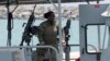 U.S. Navy personnel prepare at a patrol boat to carry journalists to see damaged oil tankers during a trip organized by the Navy for journalists, near Fujairah, June 19, 2019