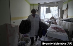 A medical worker walks inside the damaged hospital on March 9, 2022.