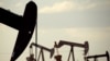 FILE - In this April 24, 2015 file photo, pumpjacks work in a field near Lovington, N.M. The boom in US oil production is expected to satisfy most of the world’s growing appetite for oil through 2023, according to a new forecast by a global energy group. 