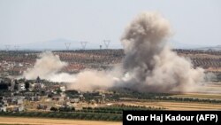 SYRIA -- Smoke billows during reported Syrian government forces' bombardments on the village of Sheikh Mustafa in the southern countryside of the jihadist-held Idlib province, May 27, 2019