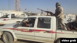 Суннитские боевики в Тикрите, июля 2014