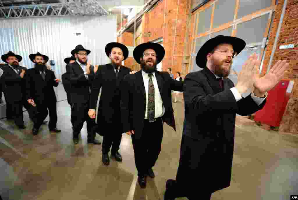 Jews sing and dance as they celebrate the handover of the Schneerson library at the Jewish Museum and Tolerance Center in Moscow on June 13. The library's Jewish archive has been the subject of a long-running dispute between Russia and the United States. (AFP/Yuri Kadobnov)