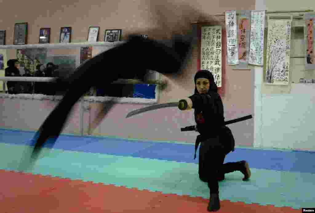 A ninjutsu practitioner jumps over a sword.