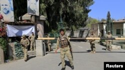 A policemen guards the provincial governor's office in Jalalabad on April 8.