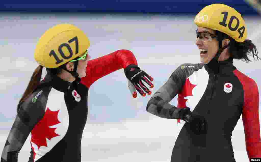 Second-placed team Canada's Valerie Maltais (left) and Marie-Eve Drolet laugh after the women's 3,000-meter short-track speed-skating relay final, won by South Korea. (Reuters/Lucy Nicholson)