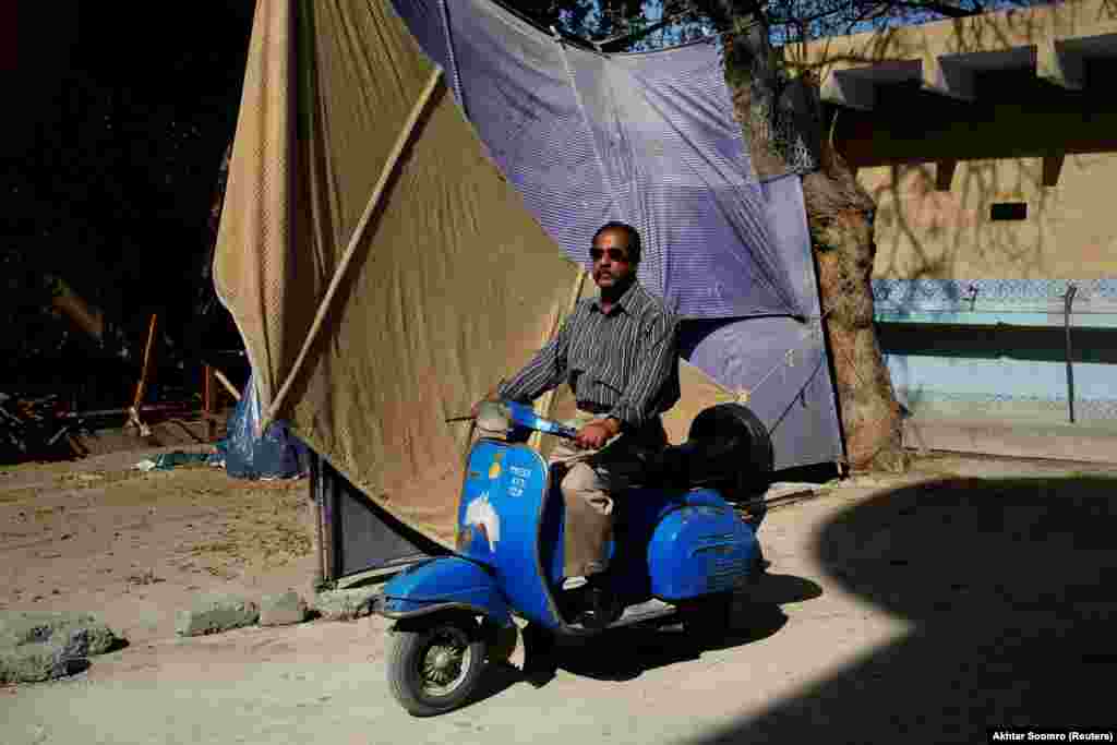 Journalist Nazeer Udding Siddiqui, 58, poses for a photograph with his 1979 Vespa in Karachi. "For me, people who own Vespas are very honorable people who still keep this tradition alive," he told Reuters. 